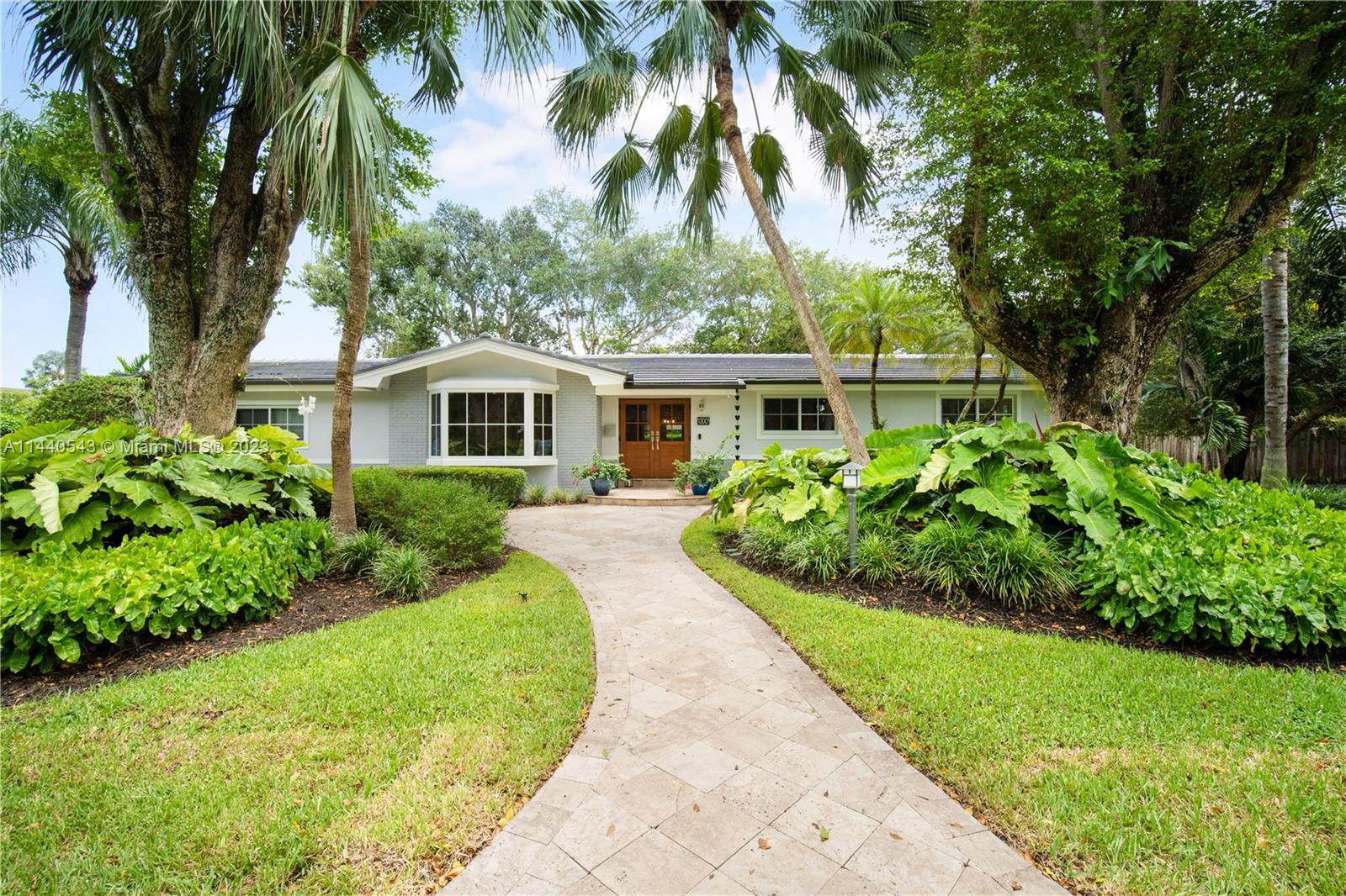 Pinecrest Palmetto Island Perfection! Rarely available and recently updated, this 3 bedroom, 2 bath home is ready for you to move right in. Enter through new stylish impact double front doors into a spacious living area with a charming window seat. The beautifully updated eat-in kitchen opens to the family room with light-filled views of the pool/patio and lushly landscaped oversized backyard with plenty of room for playing, relaxing, and entertaining. Updates include new impact windows and doors, kitchen, exterior paint, and bamboo flooring throughout. Hop on bordering paths steps away from Palmetto Middle, Palmetto Elementary, and other top-rated public and private schools. Start enjoying this sought-after neighborhood and South Florida living at its best!