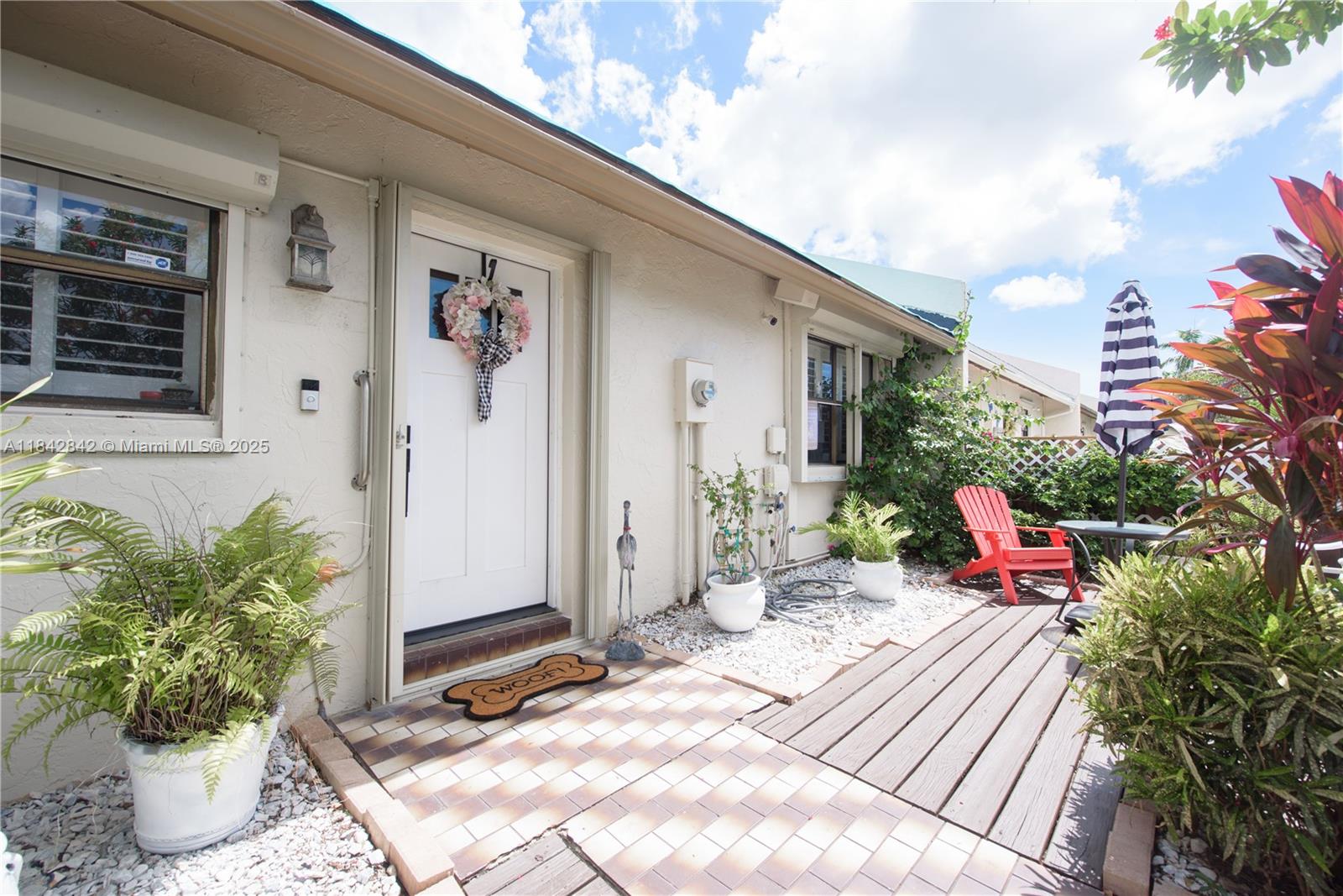 Don’t miss this desirable 2BR/2BA townhouse in sought-after Audubon South! Features include a spacious great room, kitchen w/ white cabinets, cooktop & fridge, crown ceilings in living areas & bedrooms, luxury laminate floors, Bahama blinds, roll-up shutters & wall-to-wall closets. Guest bath w/ tub/shower, primary w/ glass-door shower. Hallway washer/dryer closet. French doors open to a screened, covered patio w/ 2 fans & storage (hot water heater). Front patio included. New roof 2025. Community is conveniently located near shopping, dining & major roadways. Ideal for full-time living or seasonal use.