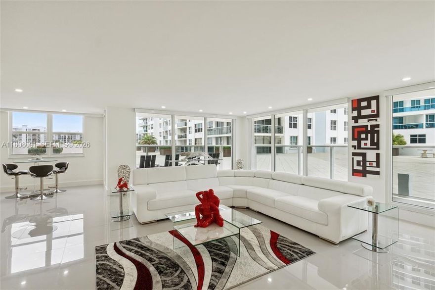The BEST VALUE ON HOLLYWOOD BEACH. Rare walk-out lanai residence at Aquarius. This fully remodelled Beach-Villa 2-bed, 2-bath corner unit offers 1,768 sq ft of effortless indoor-outdoor living with direct access to the sunset pool deck and gym, no elevators, just step outside barefoot and enjoy the resort lifestyle. Designed for a lock-and-leave second home, the open-concept layout flows seamlessly from the living area to a semi-private lanai, perfect for relaxing or entertaining. Northwest exposure fills the home with afternoon sun and glowing sunsets. Features include a custom kitchen, white porcelain floors throughout, floor-to-ceiling windows with motorized zebra blinds, and a spacious primary suite with two walk-in closets and a spa-style bath featuring a glass shower and freestanding tub. Offered fully furnished with modern furniture. Assessments paid in full. Garage parking included. Aquarius amenities include two pools, an oceanfront BBQ area, an on-site restaurant, a fitness center, valet, and 24/7 security. Vacant and easy to show, this walk-out layout is a rare opportunity. Seller is ready to entertain your offer.