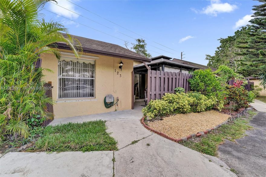 Welcome home to 123 Briarwood Circle a charming villa tucked inside a sought-after 55+ community in the heart of Hollywood, Florida! This delightful residence blends comfort, character, and the very best of Florida living. Step inside to discover a spacious open-concept living and dining area showcasing stunning wood-beamed cathedral ceilings, mirrored accent walls, and gleaming tile floors throughout. The beautiful kitchen is a true showstopper, featuring bright white cabinetry, granite countertops and full backsplash, and sleek stainless steel appliances perfect for the home chef. Enjoy outdoor living year-round in your private screened gazebo patio, plus an additional covered sunroom ideal for morning coffee, perfect for entertaining family and friends. The comfortable bedrooms offer peaceful retreats with abundant natural light, generous closet space, and a dedicated vanity area. The bathroom features a beautiful glass-enclosed shower. Lush tropical landscaping wraps the home in privacy, creating your very own backyard oasis. Located in a friendly, well-maintained 55+ community just minutes from shopping, dining, world-famous beaches, Hollywood Boulevard, and major highways. Low-maintenance living at an unbeatable price, this is the Florida lifestyle you've been waiting for! Schedule your private showing today before this gem is gone.