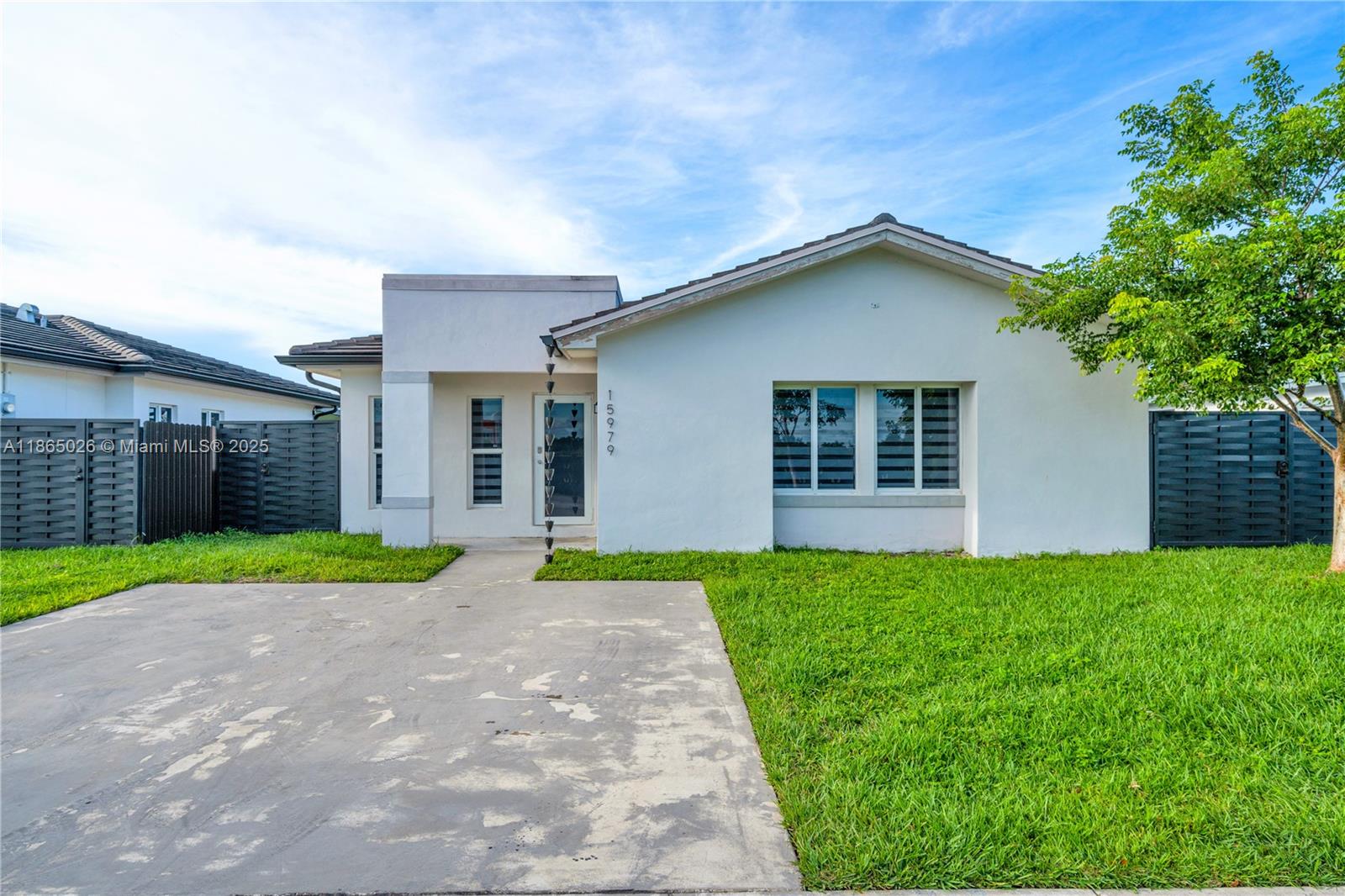 This newly constructed single-family home, built in 2021, offers modern living in the heart of Homestead. Situated on a generous lot, this 3-bedroom, 2-bathroom home features an inviting open-concept floor plan designed for comfortable living and entertaining. The kitchen is equipped with sleek quartz countertops, stainless steel appliances, and ample storage space. Enjoy peace of mind with impact windows, a full alarm system, and the convenience of an in-unit washer and dryer. Set outside to a spacious backyard, perfect for outdoor activities, with a small shed for additional storage. With no HOA, this home is move-in ready. Its central location provides easy access to shopping centers, restaurants, Baptist Homestead Hospital, and the Turnpike, making daily commutes and errands a breeze.