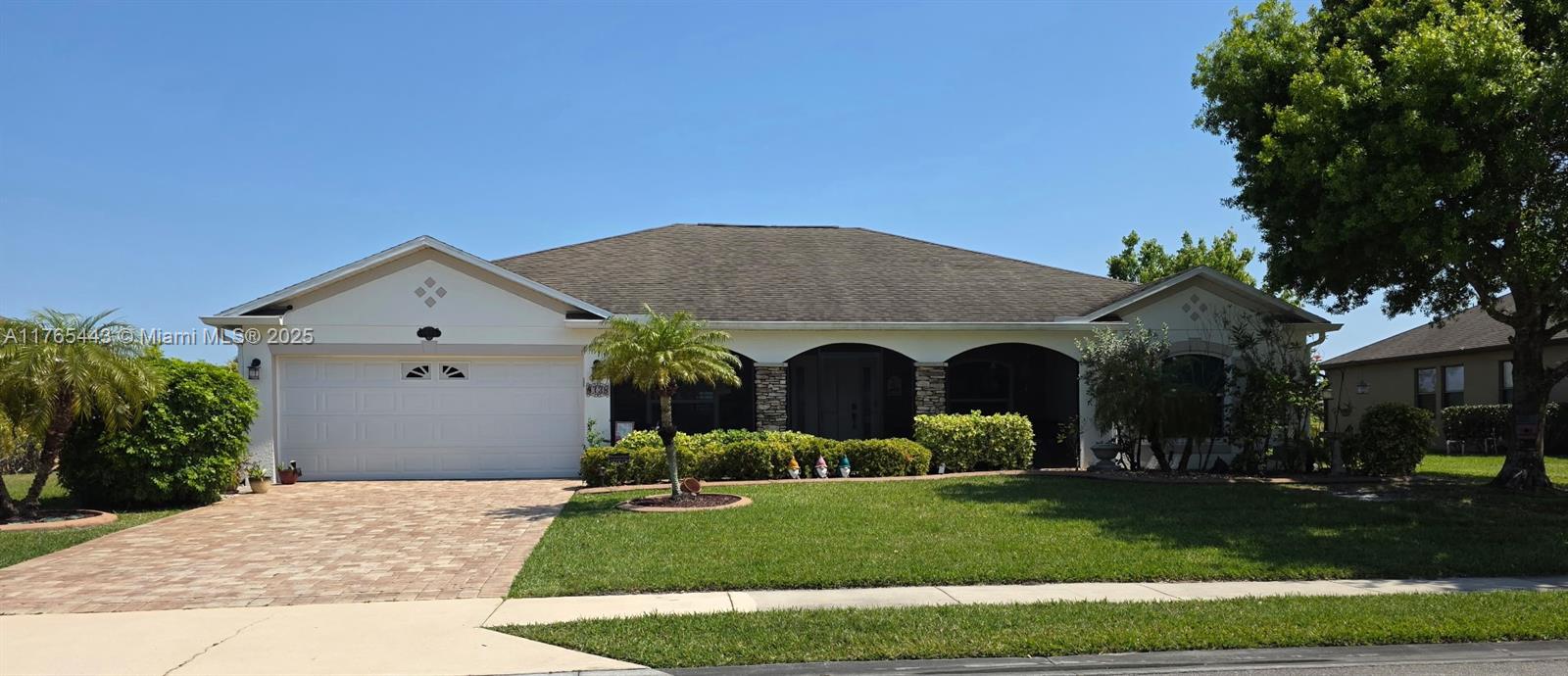 Florida living at its best! 4/2 lake front home features upgrades galore! Drive up to the paved driveway, enter the welcoming screened porch, walk into the formal living room and dining room w/high ceilings. Features 2 car garage, laundryroom, split floor plan, huge master room w/two walk-in closets. Eat-in kitchen w/island & prep sink, double pantry, open to family room making entertaining comfortable and enjoyable. Walk out to the enormous 25x40 Screened Lanai & enjoy your coffee while taking in stunning sunrises over the lake, stay enjoy the days & evenings in serenity. Updates include impact windows, backdoor & garage door, accordion shutters, extra insulation, plantation shutters, recess lighting, 7 ceiling fans, water heater 2024, AC 2021, sprinkler pump 2024, Roof 2009, & more.