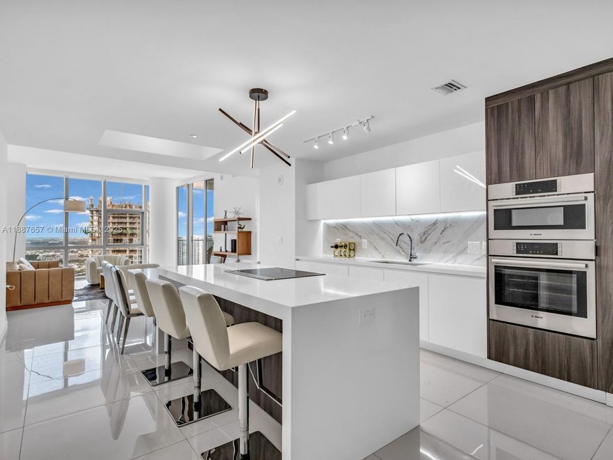 Residence 3201 defines refined contemporary living with 3 bedrooms plus 1 den and 4 beautiful baths. One of the bedrooms, enjoys a private entrance, ideal for guests or in-laws. This immaculate corner fully furnished residence showcases panoramic bay vistas through floor-to-ceiling glass. Elegant details include polished porcelain floors, soaring ceilings, and a European kitchen with glossy cabinetry and premium appliances. A private elevator ensures discretion and exclusivity. Enjoy resort-style amenities featuring multiple pools, a spa, gym, basketball and tennis courts, and a rooftop observatory. Building is a landmark located close to all action Miami has to offer. Flexible lease options available for monthly or seasonal stays (not daily); contact listing agent for information.