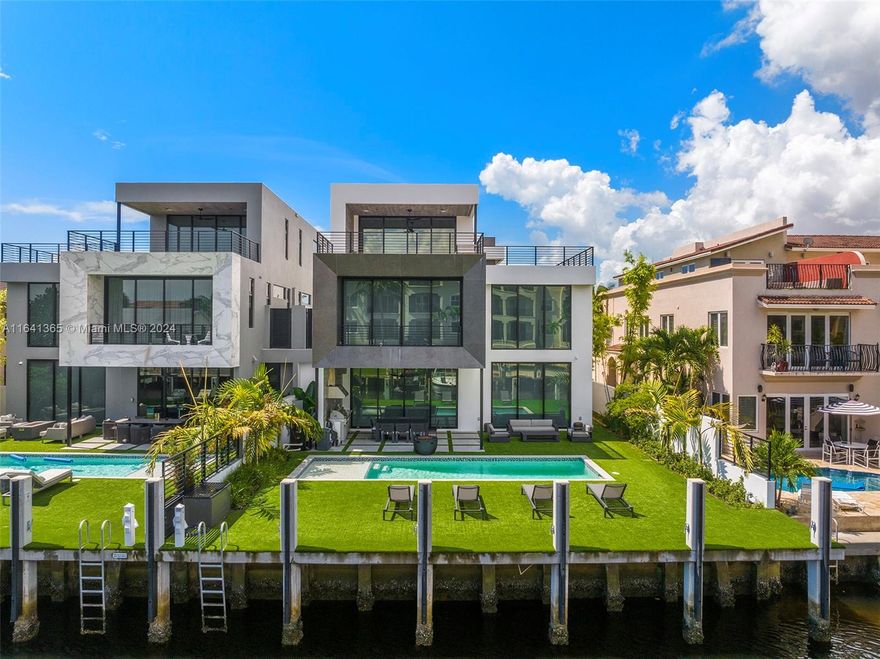 Discover unparalleled luxury in Coral Ridge with this exquisite canal-front residence in Ft. Lauderdale. This three-story home features a private elevator, a saltwater pool, and a covered summer kitchen perfect for entertaining. Enjoy panoramic views from the rooftop deck, or dock your boat at the 50ft slip. Inside, find four bedrooms plus a loft office, four full baths, and a guest bath. The Italian kitchen boasts high-end appliances, complemented by a floating steel and wood staircase, a master suite with boutique closets and a wet bar. Complete with window treatments, private entry gates, and deep-water access, this home offers both exclusivity and convenience, just minutes from the Intracoastal.