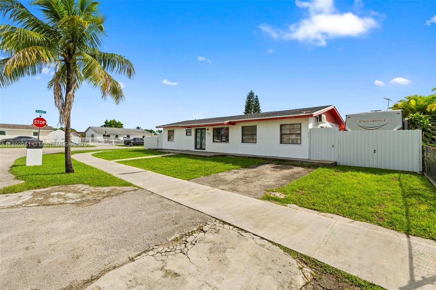 Corner lot home on a spacious fenced lot, with no HOA, offering plenty of room for a pool, RV, or other recreational vehicles. This well-maintained property features original terrazzo floors, solid construction, a split layout, an open kitchen, and an indoor laundry room. Additionally, there is an extra outdoor laundry area for added convenience. The primary bedroom has been converted into an income-generating unit, currently rented, offering additional potential income. The tenant is willing to vacate at any time if the new owner prefers. Ideal for first-time homebuyers or investors, this property offers versatility, space, and great potential for expansion or customization. Conveniently located near schools, shopping, major highways, and everything Homestead has to offer