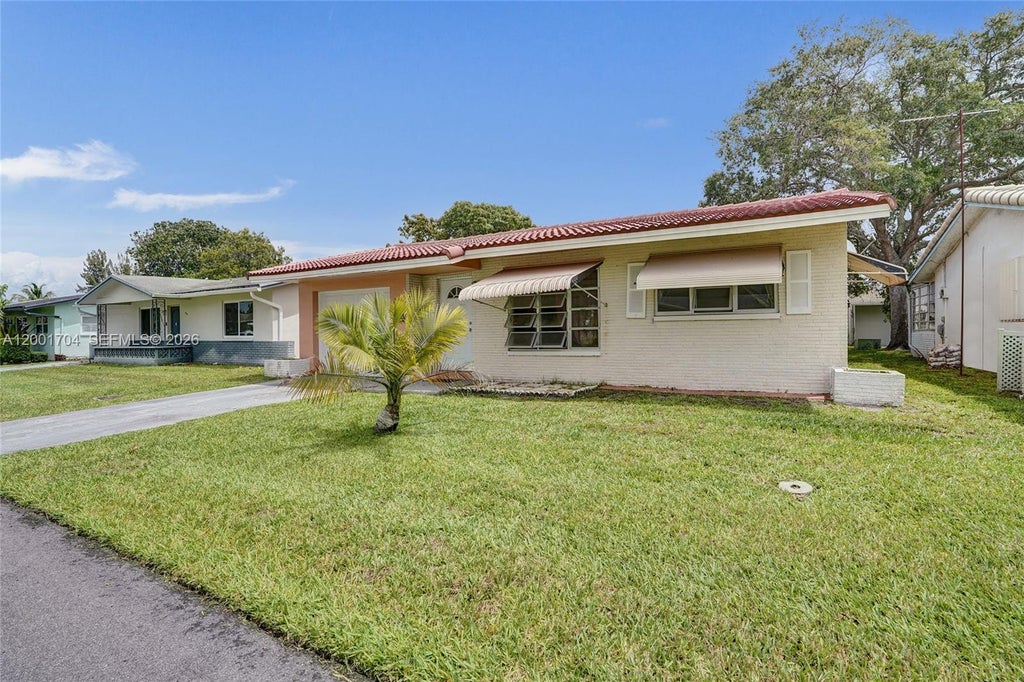 Photo of 5712 NW 66th Ave, Tamarac, FL 33321 (MLS # A12001704)