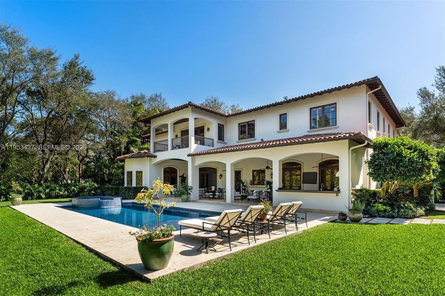 Located in the heart of North Pinecrest and just minutes from the area’s top-rated public and private schools, this exceptional estate offers 11,002 total SF on a sprawling 38,768 SF lot, delivering 7 BD and 7.5 BA with refined architectural elegance throughout. A grand arched wood and iron entry opens to soaring ceilings, marble floors, tray and coffered ceilings, crown moldings, and designer lighting. The open-concept kitchen and family room showcase Taj Mahal quartzite countertops, custom cabinetry, center island, walk-in and butler’s pantries, and premium Sub-Zero, Wolf, Miele, and ILVE appliances. Multiple living areas include formal dining, dual family rooms, wet bar with Sub-Zero wine fridge, oversized playroom with kitchen and bath (included in bedroom count), gym, staff quarters, and elevator access. Outdoors, enjoy lush landscaping, covered terraces, open balconies, a courtyard fountain, summer kitchen with Hestan grill and pizza oven, marble patios, and resort-style entertaining spaces. Additional highlights include a 6-car air-conditioned garage with EV charger, whole-house generator, Control4 smart system, central vacuum, dual laundry rooms, and a luxurious primary suite with private balcony, wet bar, spa bath, dual walk-in closets, whirlpool tub, and marble finishes—offering privacy, prestige, and premier Pinecrest living.