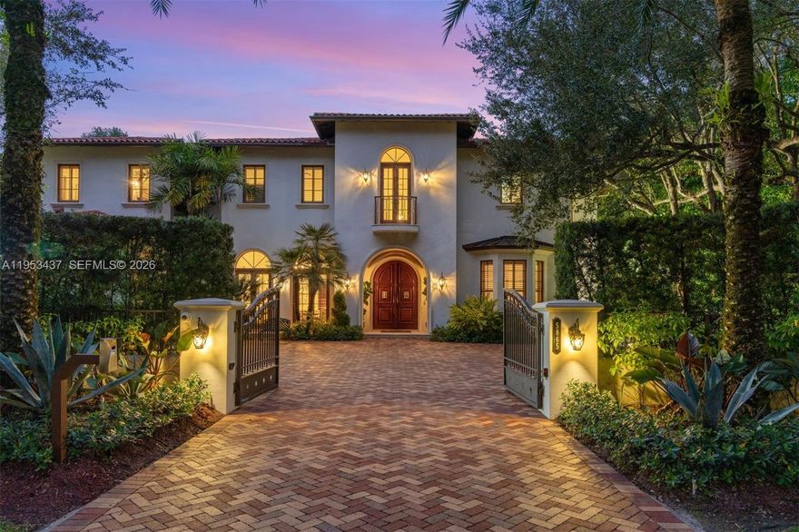 Located in the heart of North Pinecrest, this exceptional estate offers 7,811 SF under air on a sprawling 38,768 SF lot, delivering 7 BD, 7.5 BA, with refined architectural elegance throughout. A grand arched wood and iron entry opens to soaring ceilings, marble floors, and custom detailing including tray and coffered ceilings, crown moldings, and designer lighting. The open-concept kitchen and family area feature Taj Mahal quartzite countertops, custom cabinetry, center island, walk-in and butler’s pantries, and premium appliances by Sub-Zero, Wolf, Miele, and ILVE. Multiple living spaces include formal dining, dual family rooms, wet bar with Sub-Zero wine fridge, oversized playroom with kitchen and bath (included in the bedroom count), gym, staff quarters, and elevator access. Outdoor living is equally impressive with lush landscaping, covered terraces, open balconies, side courtyard with fountain, summer kitchen with Hestan grill and pizza oven, marble patios, and resort-style entertaining areas. Additional highlights include a 6-car air-conditioned garage with EV charger, whole-house generator, Control4 smart system, central vacuum, dual laundry rooms, and a luxurious primary suite with private balcony, wet bar, spa-inspired bath, dual walk-in closets, whirlpool tub, and marble finishes. This residence delivers privacy, luxury, and unparalleled Pinecrest living.
