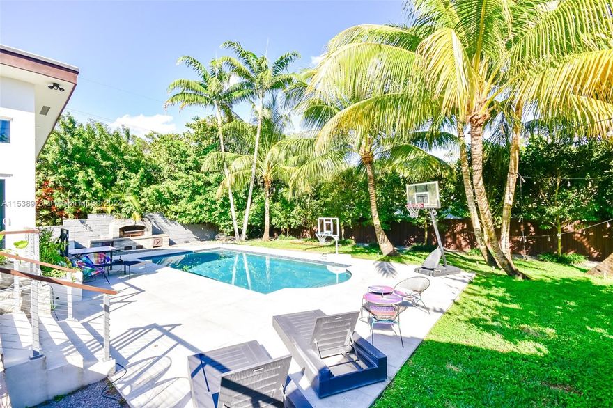 MORNINGSIDE ! This gorgeous and remodeled home features 5BR / 4.5BA . Situated on a HUGE 13,200 sqft corner lot, 2731 SQFT (total area) this charming home has a large pool and a huge private yard with a covered barbecue area. Quality ceramic tiles, impact windows and doors, Tesla Wall Chargers, remodeled kitchen and baths, lush tropical landscaping with decorative light, and a deck leading down to the large pool .