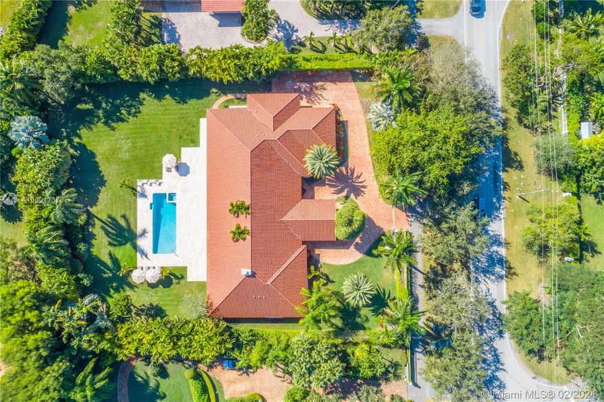 Tucked off historic Old Cutler Road, a tree-lined prestigious street in Coral Gables, a veritable paradise awaits. Here, sunlight dances across each room, lush greenery invigorates, and life unveils its most beautiful moments. Enter your gated drive with interlocking brickwork, yielding a spacious, private acre lot dotted with palms. An expansive foyer welcomes, while beyond, the one-story open plan offers endless room to play. Enjoy walk-through access to your immense backyard and inground pool, where you can cool off and sip champagne poolside. Living spaces reveal richly veined marble flooring in eye-catching contrast to bedrooms lined in lustrous dark hardwood. Decorative molding elevates crisp white walls, and drop lighting becomes a work of art in iridescent tones. Welcome home.