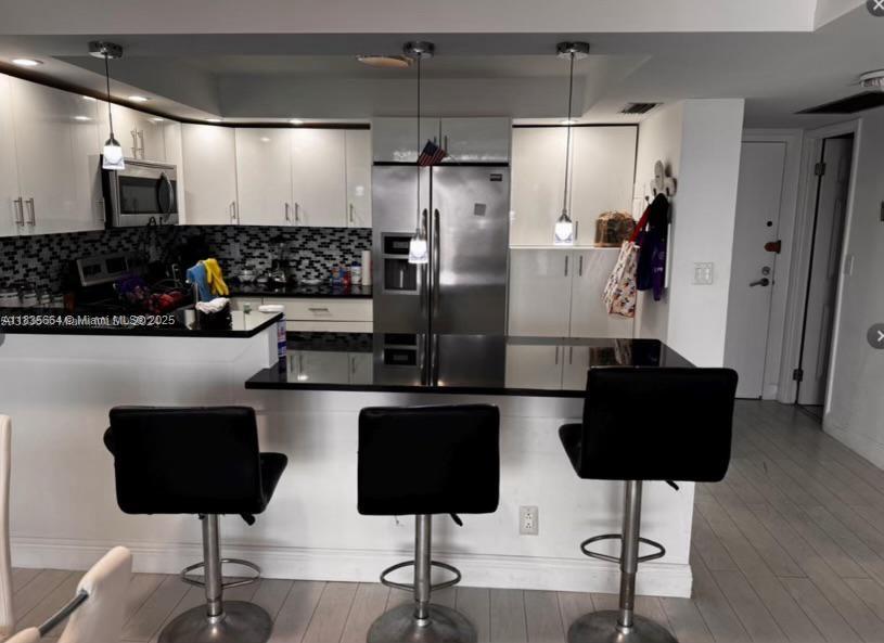 Step into this beautifully renovated building! Recently upgraded with a new roof, heated pool, elevators, hallways, exterior concrete and paint, impact windows, and balcony doors. This spacious 1-bedroom, 2-bath unit features a brand-new, open-concept kitchen with stainless steel appliances and laminate flooring. Enjoy top-tier amenities, including a heated pool, gym, and clubhouse. Located just steps from the beach, Margaritaville Hotel and the Broadwalk. The unit is easy to show, available furnished or unfurnished, and the price is negotiable. Can be rented after one year.