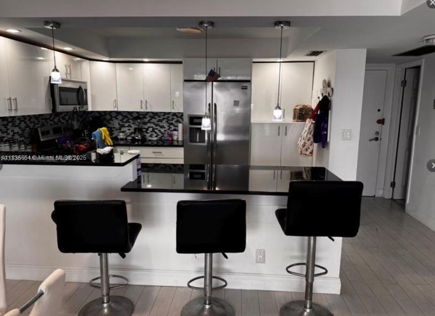 Step into this beautifully renovated building! Recently upgraded with a new roof, heated pool, elevators, hallways, exterior concrete and paint, impact windows, and balcony doors. This spacious 1-bedroom, 2-bath unit features a brand-new, open-concept kitchen with stainless steel appliances and laminate flooring. Enjoy top-tier amenities, including a heated pool, gym, and clubhouse. Located just steps from the beach, Margaritaville Hotel and the Broadwalk. The unit is easy to show, available furnished or unfurnished, and the price is negotiable. Can be rented after one year.