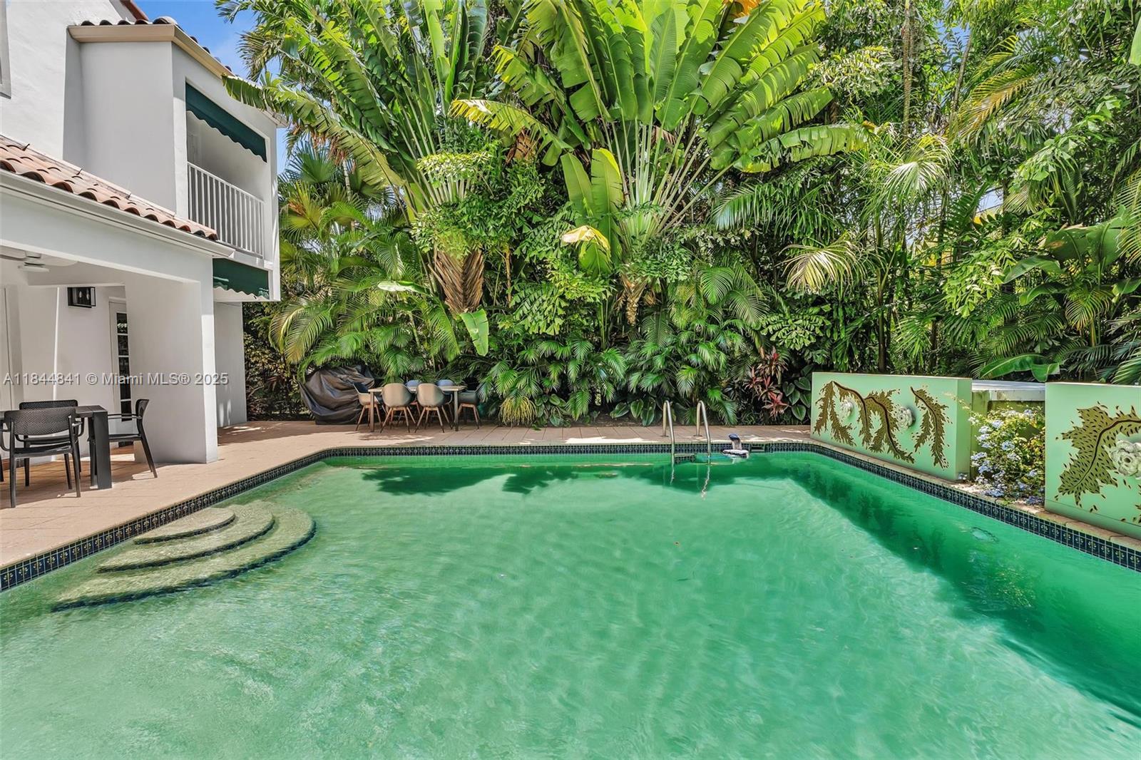 Welcome to 2516 San Domingo Street, a beautifully appointed 4-bedroom, 3-bath pool home nestled in the heart of prestigious Coral Gables. Located just a short stroll from the iconic Biltmore Hotel, this residence offers the perfect blend of elegance, comfort, and lifestyle. Featuring an open floor plan with two expansive family rooms, the home is ideal for both relaxed living and stylish entertaining. Soaring ceilings and large windows flood the interiors with natural light and provide serene views of the lush tropical landscaping that surrounds the private pool area.Enjoy the convenience of two separate car garages, and unwind in your own tranquil outdoor oasis. Live the Coral Gables lifestyle—tree-lined streets, fine dining, golf, tennis, and cultural landmarks—all just moments away.