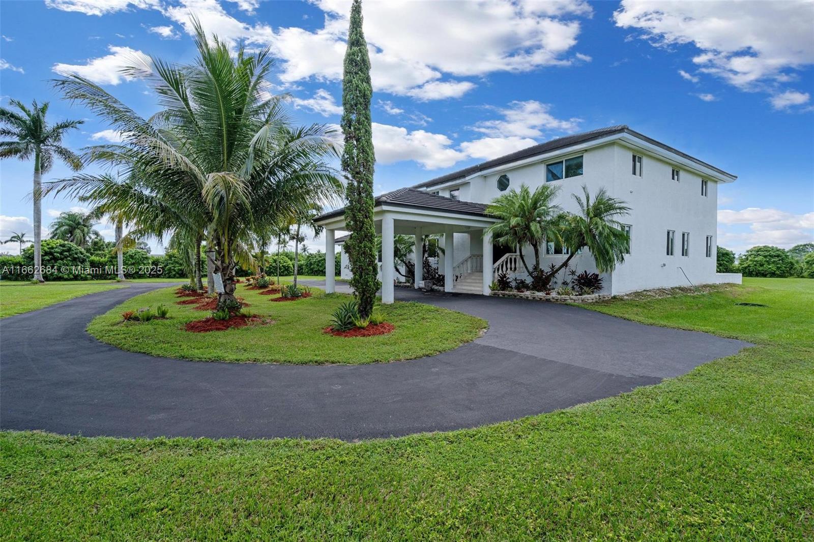 Stunning sunsets,starry nights,~3 acres of manicured grounds.Experience 'country chic' living in a picturesque setting at the end of a quiet country road bordered by the Everglades Nat'l Park,protected from over development w/ urban conveniences just 5 miles away.This luxury home offers an amazing open floor plan,spacious rooms filled w/ natural light,exquisite high end finishes throughout & a glorious primary suite.Enjoy an enormous terrace & lush back yard where one can create their outdoor oasis.Notable upgrades include:2018 concrete flat tile roof along w/ R-60 insulation,2021 impact windows & doors,'21 well & pump,'24 appliances, & so much more.The tropical fruit grove has lychee & a variety of tropical fruit earning ~$25K in income.Bring your horses,bring your toys,enjoy nature.
