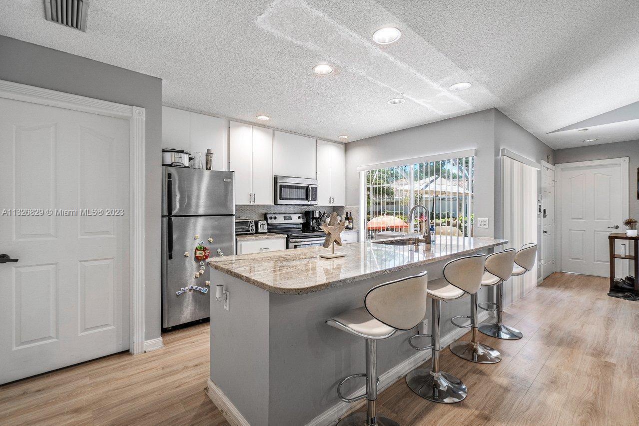 This Hidden Gem is in the highly sought-after Sun Terrace at the Gardens. This 2 bedroom 2 bath Townhome features vaulted ceilings and many updates. Located only steps away from the community pool and mailbox. Multiple sliders make this unit light and bright while large trees give shade to the large private patio. This home is just a short distance from I-95 and the Turnpike and only minutes from the beach. Note to investors: Showings are available on Tuesdays and Wednesdays between 9 AM - 5 PM.