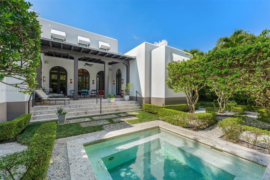 Timeless Mediterranean elegance meets refined modern living in this exquisitely designed residence. Framed by graceful arches, soaring ceilings, and black steel-framed windows and doors, the home is bathed in natural light and rich architectural character throughout. Renovated by current owners in 2022. Roof is 4 years new.
Grand living and entertaining spaces feature stone flooring, custom millwork, and curated designer lighting, creating a warm yet sophisticated ambiance. The chef’s kitchen is both functional and beautiful, offering expansive cabinetry, premium appliances including gas range, and a statement island that anchors the space while maintaining seamless sightlines through dramatic archways. Beach Club Membership.
The primary suite is a private sanctuary, complete with layered architectural detailing, serene garden views, and a spa-inspired bath featuring marble finishes, dual vanities, and a freestanding soaking tub.
Indoor-outdoor living is effortless. A covered loggia with exposed beam ceilings provides the perfect setting for lounging or dining al fresco, overlooking lush tropical landscaping. The intimate garden retreat is highlighted by a tranquil plunge pool, manicured hedges, and multiple seating areas—ideal for both relaxation and entertaining.
Blending classic Mediterranean design with modern comfort, this residence offers privacy, sophistication, and resort-style living in an exceptional setting.