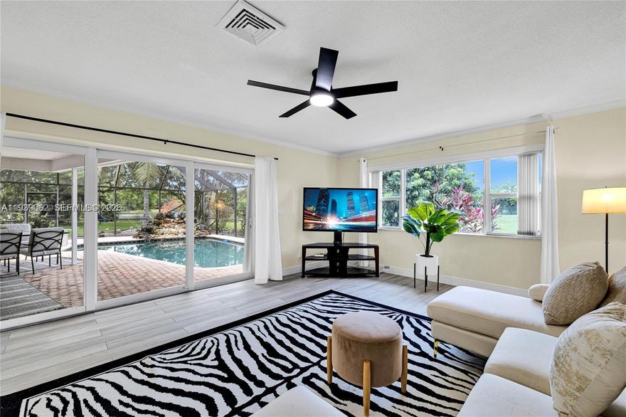 Smartly remodeled home on a quaint cul-de-sac, located in the the desirable "Woodlands". The 4-BR home features an ideal living configuration for families concept living in the common spaces & a desirable split layout for the living quarters. The living room, family room, & kitchen communicate seamlessly with the outdoor, screened-in pool area. The large pool patio enjoys peaceful views of a nearby lake. The kitchen space has ben remodeled substantially to enhance the modern look & feel of the interiors. All bathrooms have also been upgraded w/ a contemporary sensibility. Additionally, the home features a designated laundry room area which connects to the large two-car garage. Woodlands is a well-maintained community w/ approximately 890 homes; Perhaps Broward's best kept secret.