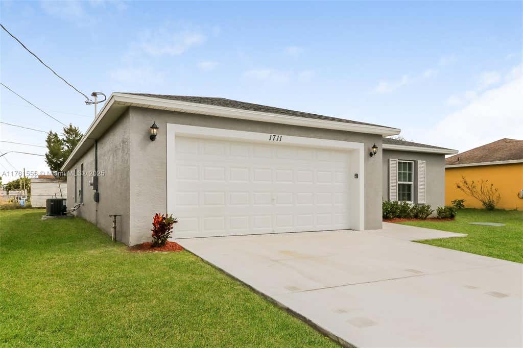 Photo of 1711 SW Bismarck St, Port Saint Lucie, FL 34953 (MLS # A11761555)