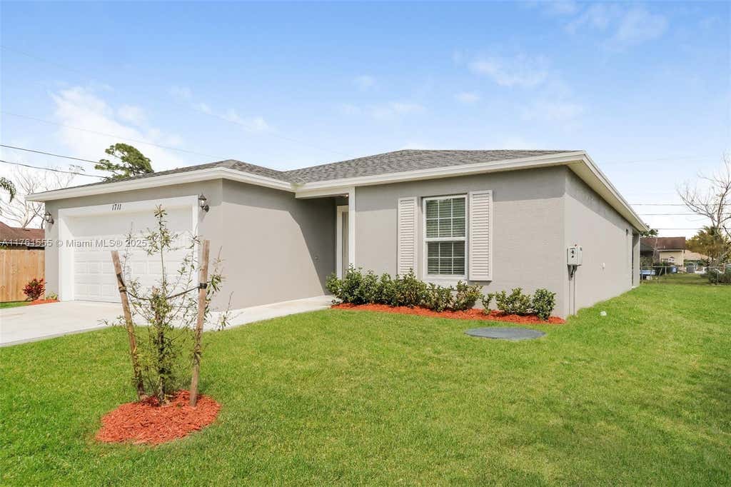 Photo of 1711 SW Bismarck St, Port Saint Lucie, FL 34953 (MLS # A11761555)