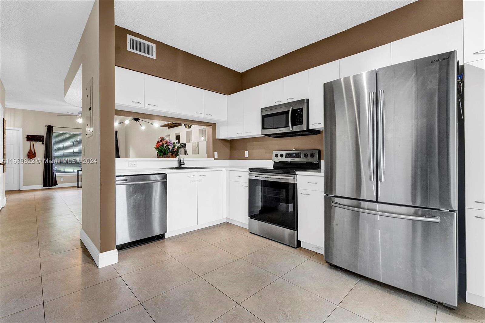 GATED LAKEFRONT GEM! Desirable lakefront, corner townhome in gated OakBridge Community. This 2-bed, 1.5-bath. $3000 SELLER CREDIT TO BUYER. Enjoy ceramic tiles on the ground floor, a modern wood laminate upstairs and volume ceilings, ample guest parking. The kitchen boasts stainless steel appliances, large pantry, washer & dryer, lighting, and ceiling fans. Freshly painted with updated baths, including new toilets and a glass shower door. Relax on the screened patio overlooking the lake and BBQ in your backyard. Pet-friendly, rentable, with a low HOA covering exterior insurance, roof, lawn, community pool, clubhouse, and tot lot. Storage room included. Close to Publix, houses of worship, Hard Rock, I-95, 441, FTL airport, Dania Point Shopping & Restaurants, Las Olas, and the beach!