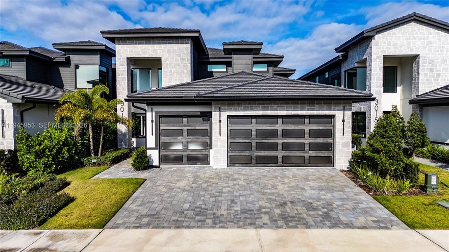 Welcome to this elegantly appointed residence, located in the exclusive gated community of Hampton Green at Providence. This home is fully upgraded with Stone Modern exterior,  coach lights and expansive 3 car garage, huge rear lanai with hidden roll-down screens, high 20' ceilings and grand entryway. The kitchen is a statement with incredible all glass pantry doors, builtin hood. Designer tile throughout on first floor, real wood on the stairs and 2nd floor. Ideal for discerning buyers seeking a luxury and calm retreat, Large balcony overlooks the par 3 seventeenth hole at Providence Golf Club, electric fireplace with gorgeous soaring stone wall, This home is the epitome of luxurious golf community living. Over 75k in interior decoration, Designer left no details behind. Premium amenities such as clubhouse, fitness center, tennis courts, golf courts, and more.