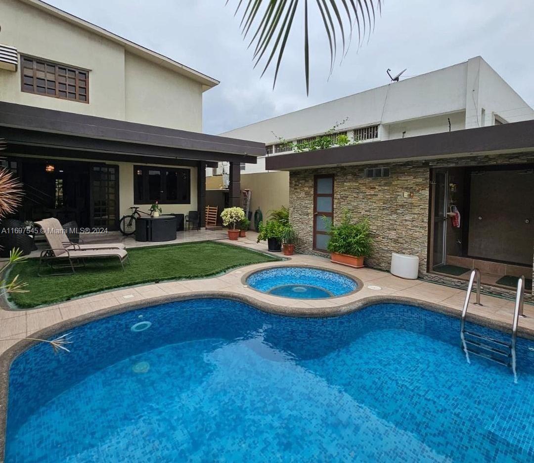 Beautiful two-story home with top quality finishes and porcelain tiled floors, located inside the gated community of Los Ceibos in Guayaquil-Ecuador. 
The first floor has a welcoming entrance, an office/study room, half bath, living-dining room, kitchen and laundry room.  Off the first floor you will find an inviting terrace with a pool, hot tub, sauna and steam bath and a full bathroom.
The second floor has a family room, three bedrooms with their own bathrooms and closets.
