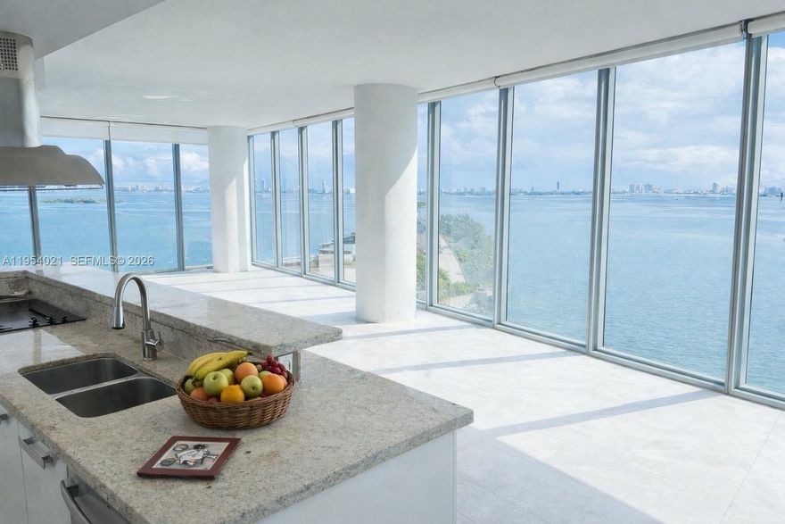 Spacious 1,870 sq ft corner residence in one of the most desirable lines in the building, offering unobstructed water views from every window and showcasing the bay and Miami Beach with excellent natural light and privacy. The floor plan features two generous bedrooms with en-suite baths, a third full bathroom, and an oversized living and dining area with excellent flow for everyday living and entertaining. Floor-to-ceiling windows wrap the residence, maximizing water views throughout, and are equipped with motorized shades and drapes controlled by remote. The unit includes two assigned garage parking spaces, one valet parking space, and one assigned storage unit. Full-service building amenities include multiple pools, fitness center, spa, media and party rooms, business center, dog park, valet service for residents and visitors, and 24-hour security. Ideally located near the Design District, Midtown, Edgewater, Downtown, and Miami Beach.
Photos are of the actual unit. Furniture has been digitally removed to better illustrate the space and layout.