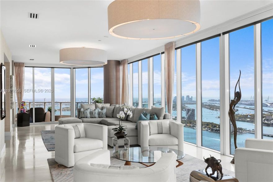 The ONLY true penthouse at 2020 N Bayshore Drive, PH4702 offers unobstructed 360° views of Biscayne Bay, Miami Beach, and the Miami skyline from the 47th floor. With 4 bedrooms, 4.5 bathrooms and 4,055 sqft of interior space, matching the largest floor plan in the building.  Designed for indoor-outdoor living, it features 4 private balconies capturing sunrise and sunset, providing comfortable outdoor spaces year-round. Unlike oversized terraces exposed to wind, heat and rain, the balconies offer a more usable outdoor retreat. A private elevator opens directly into the foyer. Walls of glass flood the interiors with natural light, highlighting spacious living and dining areas and the split-bedroom layout. The primary suite offers water views, a spa-inspired bath and expansive closets. The fourth bedroom is ideal for in-law accommodations, staff quarters or a private office. The kitchen features Wolf appliances, including a wine cooler, dual ovens and a Miele coffee maker. The residence is featured in "Some Like It Hot: Inspiring Spaces By Florida's Hottest Designers," showcasing its design by Whitney Bloom. Located in Paramount Bay, designed by Arquitectonica with interiors by Lenny Kravitz’s, offering walkability to Whole Foods, Publix, Margaret Pace Park, and waterfront restaurants like Klaw, Casadonna and Amara. Located less than 20 mins from Miami Airport, Miami Beach, the Design District and Brickell, and near Art Basel and the Miami International Boat Show.