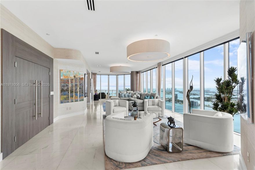 A top-floor true penthouse at 2020 N Bayshore Drive, PH4702 offers unobstructed 360° views of Biscayne Bay, Miami Beach, and the Miami skyline from the 47th floor. With 4 bedrooms, 4.5 bathrooms and 4,055 sqft of interior space, matching the largest floor plan in the building.  Designed for indoor-outdoor living, it features 4 private balconies capturing sunrise and sunset, providing comfortable outdoor spaces year-round. Unlike oversized terraces exposed to wind, heat and rain, the balconies offer a more usable outdoor retreat. A private elevator opens directly into the foyer. Walls of glass flood the interiors with natural light, highlighting spacious living and dining areas and the split-bedroom layout. The primary suite offers water views, a spa-inspired bath and expansive closets. The fourth bedroom is ideal for in-law accommodations, staff quarters or a private office. The kitchen features Wolf appliances, including a wine cooler, dual ovens and a Miele coffee maker. The residence is featured in "Some Like It Hot: Inspiring Spaces By Florida's Hottest Designers," showcasing its design by Whitney Bloom. Located in Paramount Bay, designed by Arquitectonica with interiors by Lenny Kravitz’s, offering walkability to Whole Foods, Publix, Margaret Pace Park, and waterfront restaurants like Klaw, Casadonna and Amara. Located less than 20 mins from Miami Airport, Miami Beach, the Design District and Brickell, and near Art Basel and the Miami International Boat Show.