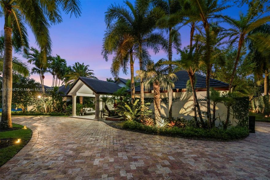 This exquisite 2-story retreat is a family dream home, featuring 6 BR, 6 BA and a myriad of contemporary comforts & conveniences. Designer details abound including custom millwork & vaulted cedar ceilings. The chef-style kitchen is replete w/ high-end appliances, finishes & a large island w/ quartzite countertops.  The family room showcasing coffered ceilings features a wet bar & Sonos sound system. The owners’ suite is a standout w/ a large den, custom oak herringbone floors, a walk-in closet w/ granite island & French doors that open to a balcony. Likened to a resort-style oasis, the backyard stuns with a heated pool, optional saltwater system, large jacuzzi & tennis court.  Additional features include impact windows, phone-activated sprinklers, security system & full-home generator.