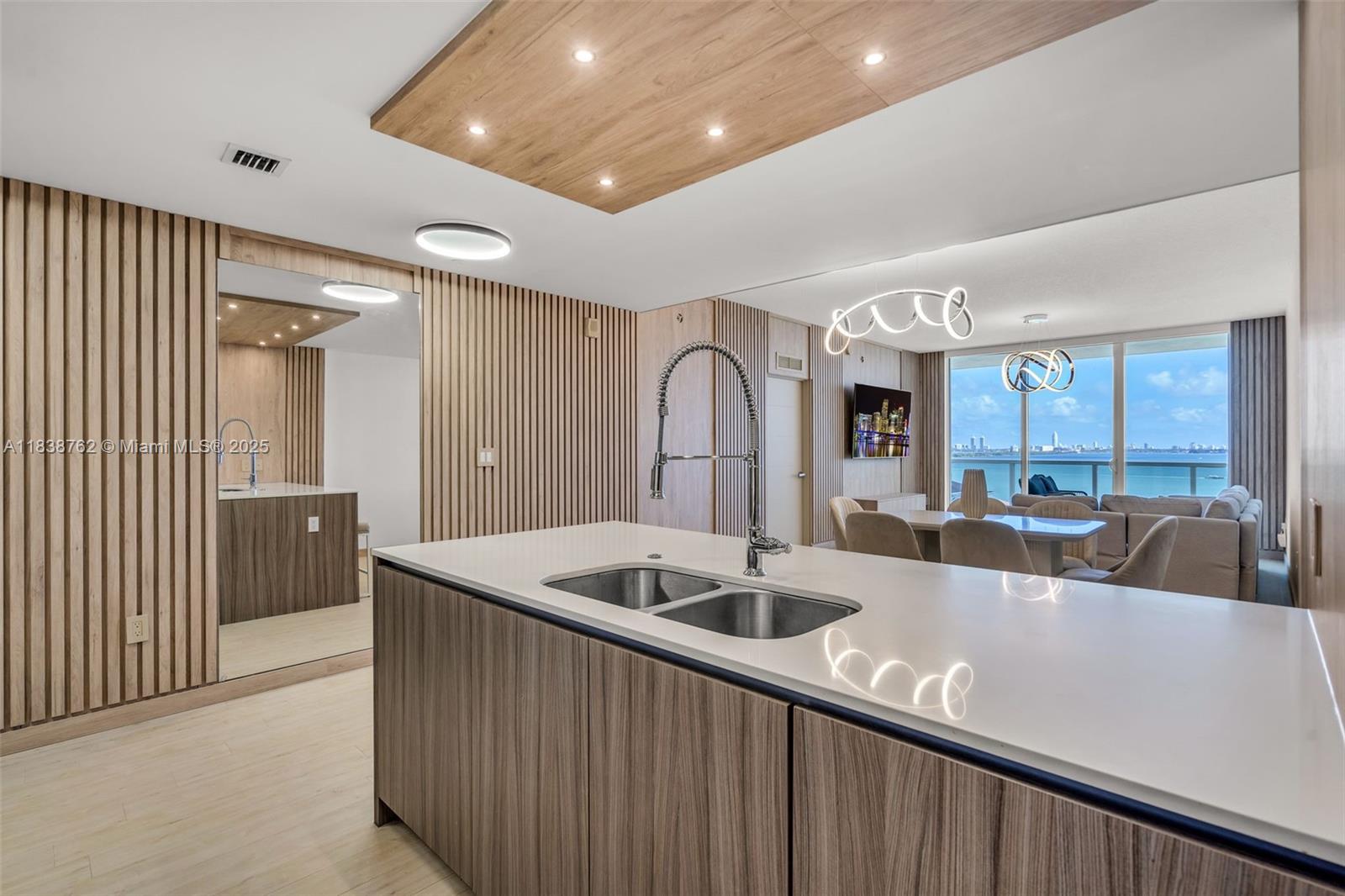 Live in the heart of Edgewater! FULLY FURNISHED. This stunning 3 bed/3 bath residence features a panoramic bay & city views. Modern wooden panels and luxury wallpaper throughout create a sophisticated ambiance. Spacious open-concept layout with high ceilings, Italian cabinetry, custom closets & designer lighting. Expansive balcony perfect for enjoying Miami sunrises & sunsets. Full-service building with resort-style amenities—pool, state-of-the-art gym, business center & more. 2 assigned parking spaces. Minutes to Wynwood, Midtown, Design District, Brickell & Miami Beach. Don't miss this opportunity!