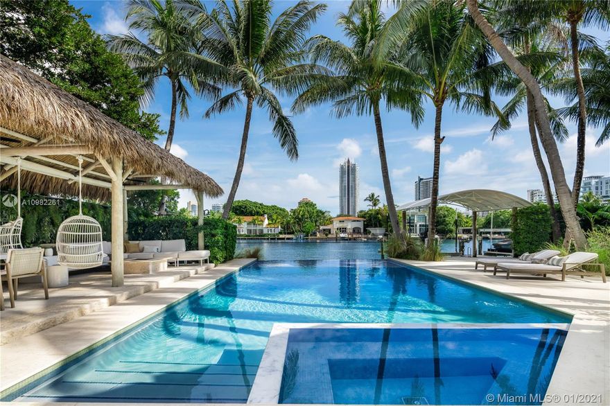 Impeccably designed, recent complete renovation. Built by renowned Miami Beach architect Russell Pancoast, a truly remarkable find on highly desirable Pine Tree Dr. Abounding with sumptuous amenities, this extraordinary gated 6,970 SF residence boasts 100’ of WF on 20,900 SF. The home’s features include a complete professional interior redesign, stunning gardens, full courtyard bar, Lutron smart home system, media room w/ custom New York Style “speakeasy” bar, housekeepers wing, butler’s kitchen, fully-equipped gym w/ Cybex & Precor machines, separate guest cottage, Waterworks fixtures in bathrooms, principal suite w/ custom shelving, dual closets. Resort-style backyard w/ sparkling pool, fire pit lounge, custom outdoor kitchen, private dock w/ SUP stand, 2 jetski bunks & large boat lift.