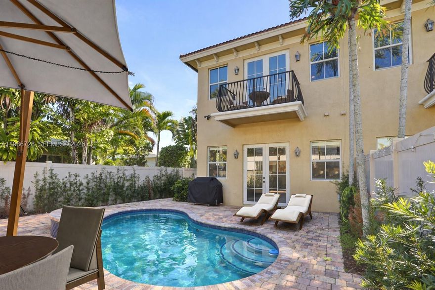 Turnkey and beautifully upgraded, this standout Villa Valentina corner-unit townhouse offers the ultimate Fort Lauderdale lifestyle. Enjoy your own private resurfaced pool with expanded pavers, plus convenient side access to the rear garden—ideal for entertaining and outdoor living. The home also features a private two-car garage with elevated storage and an EV charger. Inside, the 3-bedroom, 2.5-bath layout showcases soaring ceilings, quartz countertops, 2023 KitchenAid appliances, LED lighting, a sleek modern electric fireplace, and high-end designer finishes throughout. The primary suite is a true retreat with dual walk-in closets and a spa-style bath complete with a freestanding tub and dual rainfall showers. Impact glass, smart home features, refreshed landscaping, and HOA coverage that includes insurance add exceptional value and peace of mind. Just minutes from the beach, Las Olas, and downtown hotspots.