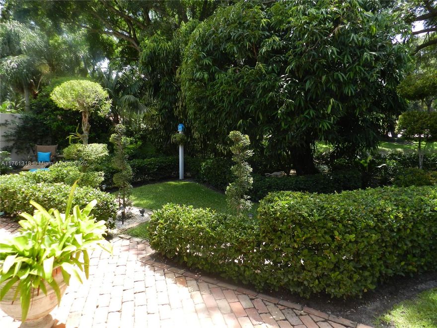 MOST MAGICAL GARDEN  OAKS EAST. AS you stroll thru lovely bricked paths, you will find fountain, topiaries, rose garden & much more. Traditional home seeks appreciative new owner to plant flowers and enjoy the peace &  serenity of  masterful garden home. Many amenities include, Plantation shutters, crown molding, fans, updated light fixtures including Maitland Smith Vintage Penshell Chandelier, Rare Thassos marble vanity in guest  bathroom, as well as, Crema Marfil Marble counter top in primary bathroom  upgraded medicine chest & fixtures. Third bedroom converted to stunning library amazingl built-ins.  Custom cabinetry, epoxy floor enhance garage.   24 manned gated community with community heated pool    Seller will consider selling furniture and art.  Make an offer - seller will listen!