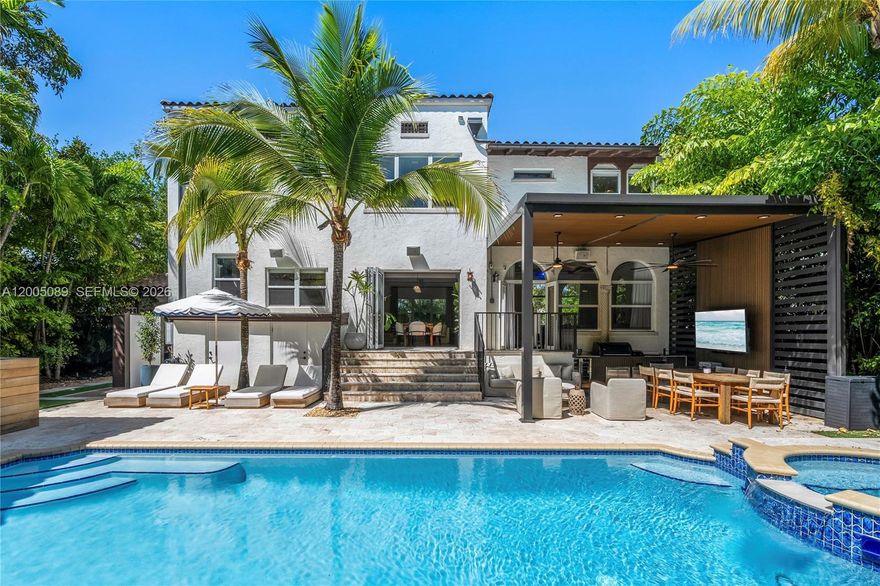 A reimagined Mediterranean estate blending timeless architecture with tropical modernism. While the exterior captures an architectural renaissance that only exists in history, the interior is basked in modern finishes and features. The interior walls are coated with limewash, which pairs perfectly the hardwood floors and Calacatta marble fireplace. The house flows magestically, anchored by oversized rooms. Offering 4 bedrooms and 4 bathrooms, including a luxurious guest house with its own kitchenette. The home is designed for comfort and style. The kitchen features Dakota marble countertops, and a full suite of Sub-Zero and Wolf appliances. A fully functioning smart house, Control4 seamlessly integrates sound, lighting, shades, and drapes throughout the home. The expansive primary bedroom feels like a luxurious retreat, including a private home office, massive walk-in closet, and a beautiful bathroom. The backyard is your own private resort, prime for outdoor living and entertaining. Featuring a fully equipped summer kitchen covered by a pergola, multiple lounge and dining areas, an outdoor audio and visual entertainment system, cold plunge, infrared sauna, and outdoor shower. The pool is larger than life, accented by a raised waterfall spa. Only three blocks from the Design District, you can indulge in Miami's finest restaurants, and designer stores.