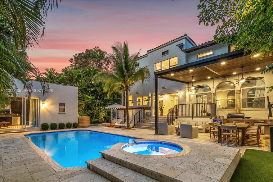 A reimagined Mediterranean estate blending timeless architecture with tropical modernism. While the exterior captures an architectural renaissance that only exists in history, the interior is basked in modern finishes and features. The interior walls are coated with limewash, which pairs perfectly the hardwood floors and Calacatta marble fireplace. The house flows magestically, anchored by oversized rooms. Offering 4 bedrooms and 4 bathrooms, including a luxurious guest house with its own kitchenette. The home is designed for comfort and style. The kitchen features Dakota marble countertops, and a full suite of Sub-Zero and Wolf appliances. A fully functioning smart house, Control4 seamlessly integrates sound, lighting, shades, and drapes throughout the home. The expansive primary bedroom feels like a luxurious retreat, including a private home office, massive walk-in closet, and a beautiful bathroom. The backyard is your own private resort, prime for outdoor living and entertaining. Featuring a fully equipped summer kitchen covered by a pergola, multiple lounge and dining areas, an outdoor audio and visual entertainment system, cold plunge, infrared sauna, and outdoor shower. The pool is larger than life, accented by a raised waterfall spa. Only three blocks from the Design District, you can indulge in Miami's finest restaurants, and designer stores.