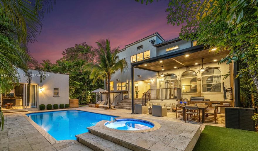 A reimagined Mediterranean estate blending timeless architecture with tropical modernism. While the exterior captures an architectural renaissance that only exists in history, the interior is basked in modern finishes and features. The interior walls are coated with limewash, which pairs perfectly the hardwood floors and Calacatta marble fireplace. The house flows magestically, anchored by oversized rooms. Offering 4 bedrooms and 4 bathrooms, including a luxurious guest house with its own kitchenette. The home is designed for comfort and style. The kitchen features Dakota marble countertops, and a full suite of Sub-Zero and Wolf appliances. A fully functioning smart house, Control4 seamlessly integrates sound, lighting, shades, and drapes throughout the home. The expansive primary bedroom feels like a luxurious retreat, including a private home office, massive walk-in closet, and a beautiful bathroom. The backyard is your own private resort, prime for outdoor living and entertaining. Featuring a fully equipped summer kitchen covered by a pergola, multiple lounge and dining areas, an outdoor audio and visual entertainment system, cold plunge, infrared sauna, and outdoor shower. The pool is larger than life, accented by a raised waterfall spa. Only three blocks from the Design District, you can indulge in Miami's finest restaurants, and designer stores.