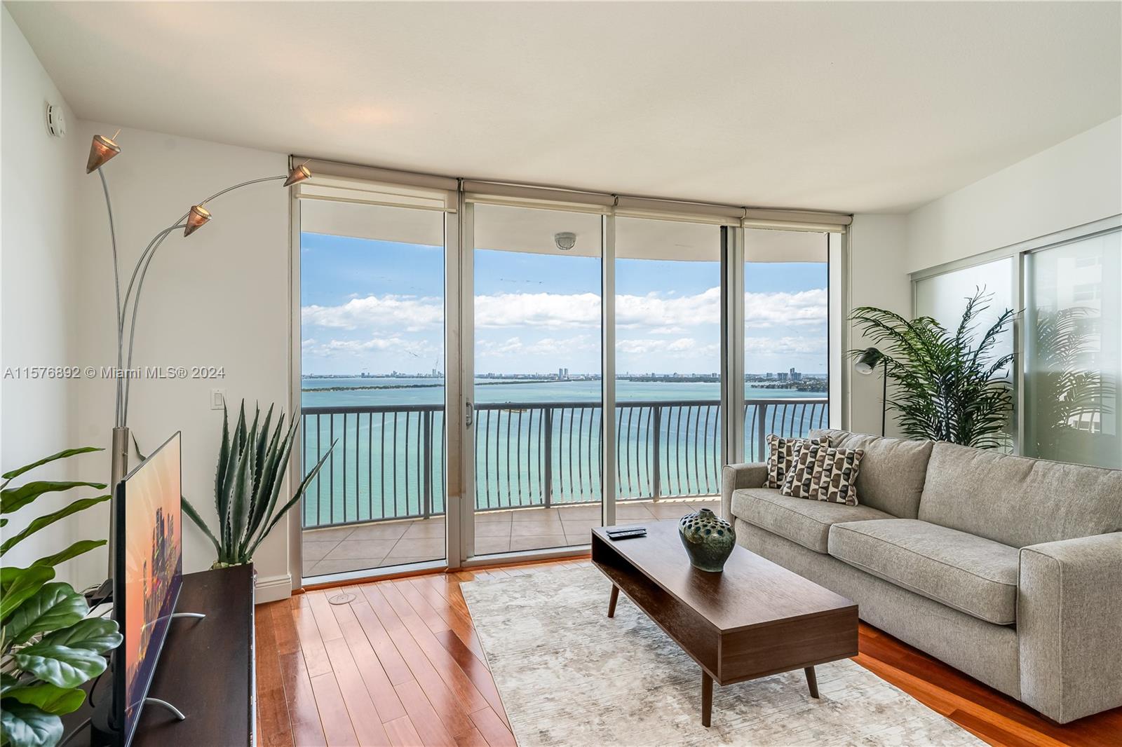 Welcome home! Discover your extraordinary new sky home features floor-to-ceiling glass walls with direct bay & ocean views- your new home is drenched in natural light & has gleaming hardwood floors, onyx backsplash & a huge master suite with walk-in closet & upgraded bathrooms. Sliding glass partitions open up to 2nd bedroom expanding living area and views. A huge terrace extends the entire length of the condo - washer and dryer inside the unit. One cover garage parking AMAZING! Located in Performing Arts District- onsite dining, sundry store, salon & recreational park in front.