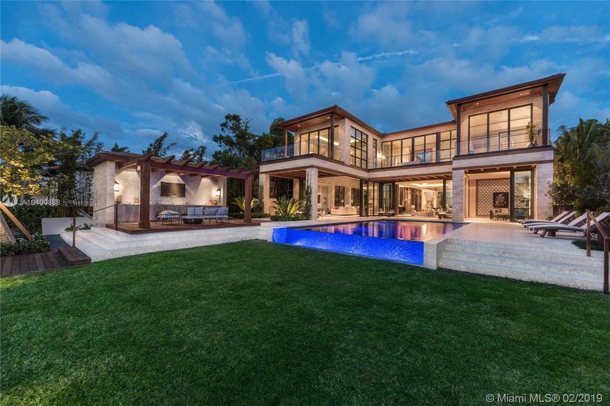 Brand new contemporary Bayfront mansion with strikingly unique design & abundance of lavish finishes to complete its extravagant appeal. The grand atrium room with its 30-ft tall ceilings will instantly captivate your attention & welcome you to the spectacular waterfront living room with fireplace. Inside, custom Italian kitchen with family room, formal dining, 2 independently-controlled wine cellars, 159' theater with a wet bar, gym, office, elevator, master suite with 2 marble baths & 2 walk-in closets, flourishing interior gardens with fountains, & many terraces. Flawlessly connecting with the interior spaces is the lush backyard with a gas-heated pool, Argentine grill, cabana bath, & new IPE dock suitable for large yachts. Gated 10,665-sf home, 21,228-sf lot, 85-ft WF, 3-car garage.