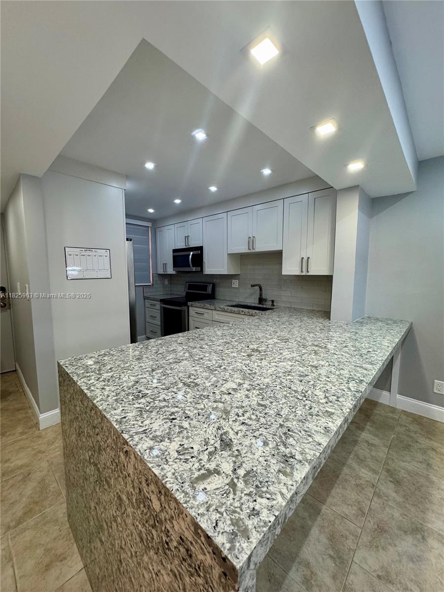 Welcome to your new home in the heart of beautiful Coral Springs! Spacious 2-bedroom, 2-bathroom condo offers the perfect blend of comfort and modern living. Open-concept living and dining area with plenty of natural light and tile flooring throughout. The kitchen features updated appliances, ample cabinet space, and a breakfast bar perfect for casual dining or entertaining guests The primary bedroom includes an en-suite bathroom and a large walk-in closet, while the second bedroom is generously sized—ideal for a guest room, home office, or family member. Both bathrooms are well-appointed with modern fixtures and full tubs/showers. Enjoy your private screened-in balcony, perfect for morning coffee or relaxing evenings. The unit also includes in-unit laundry and assigned parking.
