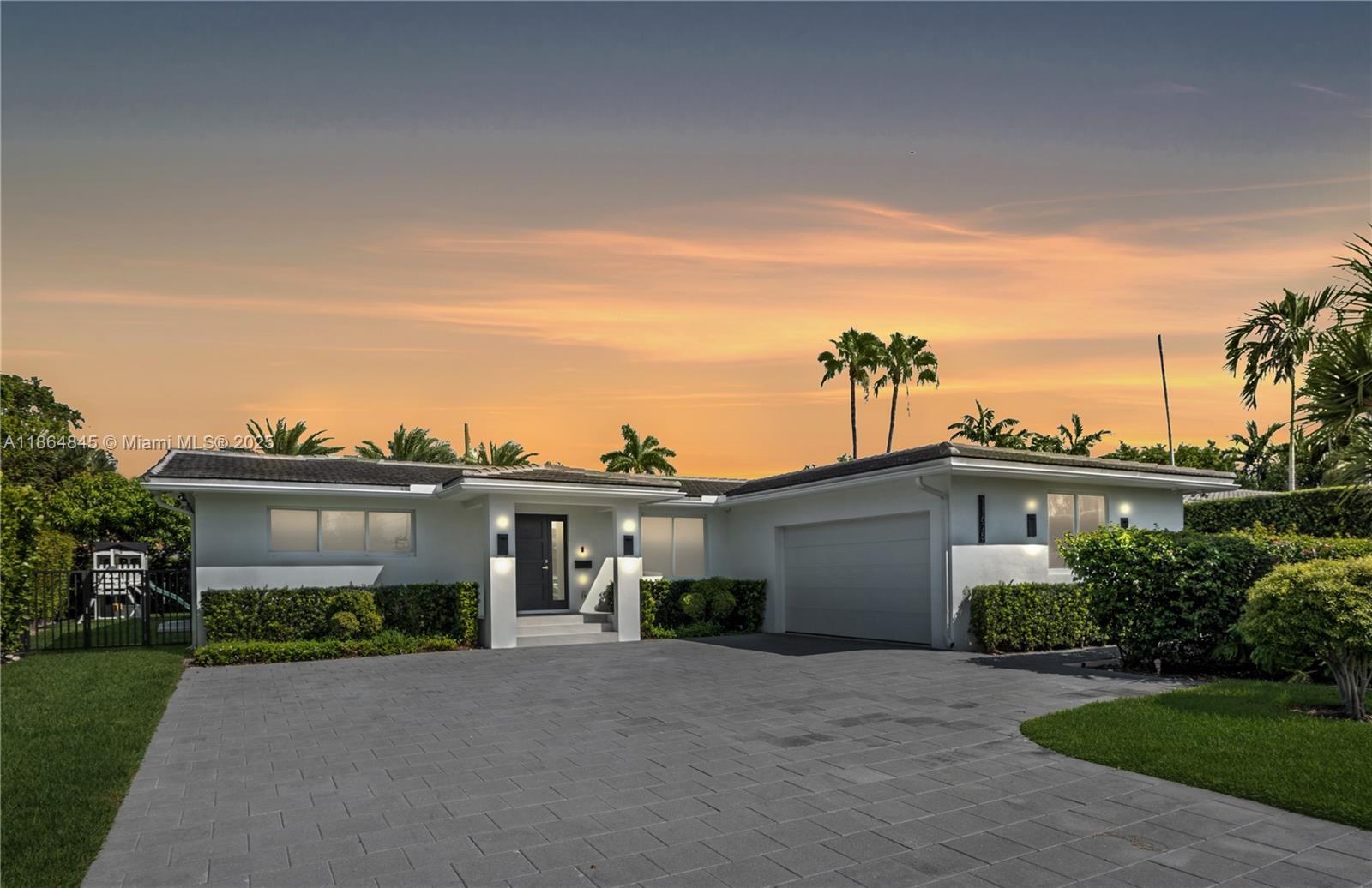 Modern Executive Style home in 24HR guard-gated Sans Souci Estates. 2,580 SF of AC living space, 3,323 SF under roof, boasting 4br 3ba & 2car gar w/AC. Whole-house generator w/automatic transfer switch, hurricane impact windows/doors, & new 2020 roof. Gourmet kitchen crafted by Mia Cucina with top-of-the-line JennAir appliances, including double 30" ovens & microwave drawer. Spa-like master bath is a Mia Cucina design, w/spa tub & separate Shower. Porcelain tile flrs, custom California closets in all rooms, new washer & dryer. Step outside to backyard with huge 350SF covered patio w/built-in BBQ + space for pool, even a private putting green. Sprinkler/irrigation system, 2nd refrigerator in garage. Home offers luxury and security in one of North Miami’s most desirable neighborhoods.