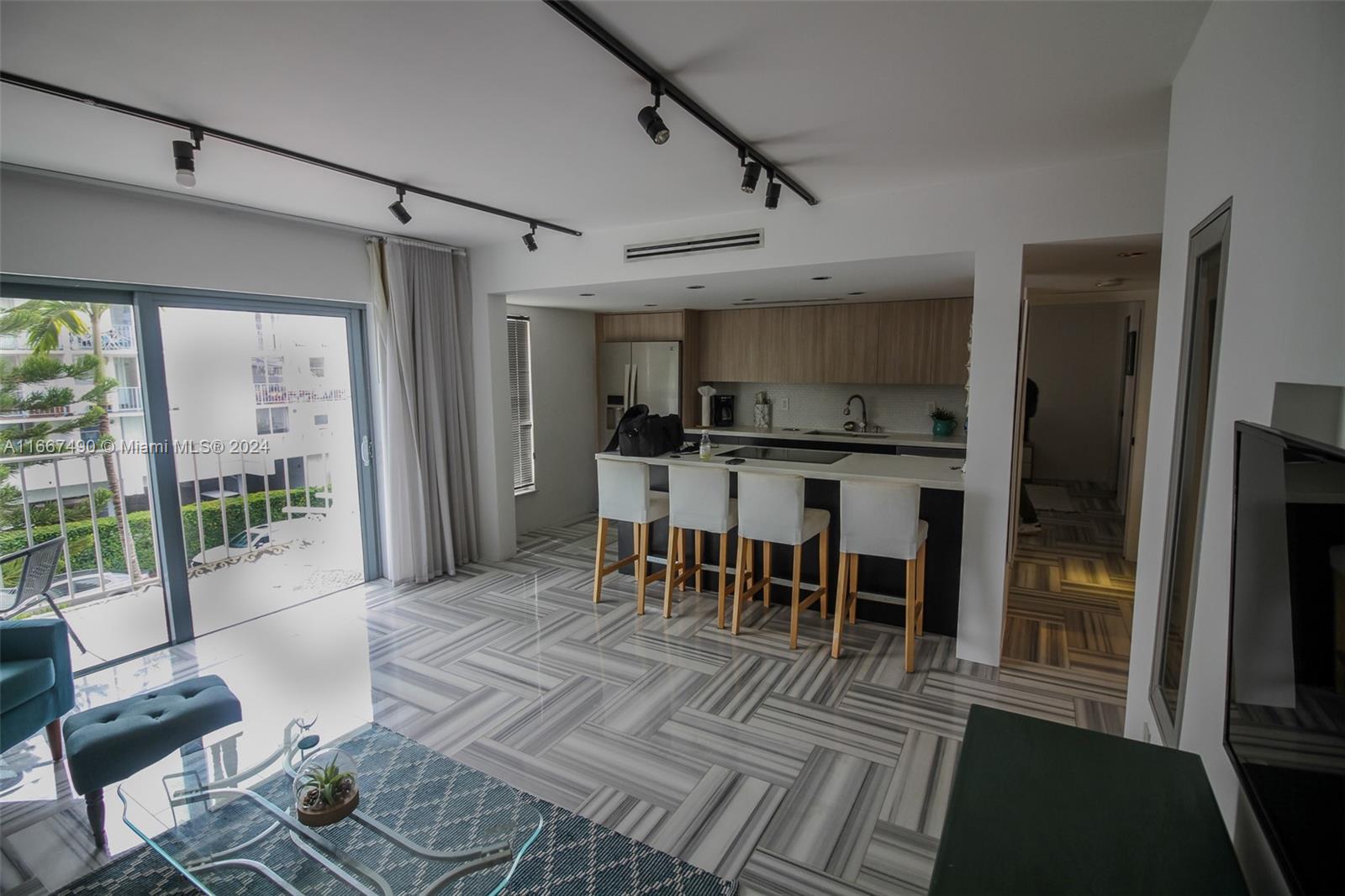 Experience this renovated stunning designer unit where no detail has been overlooked. Featuring two spacious bedrooms and two full bathrooms, including a master suite with a walk-in closet. The unit boasts marble flooring throughout and a newer HVAC system. The open kitchen includes a cooking island, perfect for entertaining. Step out onto the south-facing balcony and enjoy the views. The unit comes with an assigned parking space in a secure, gated property with intercom access. The building also offers a private heated pool for residents. This is a must-see