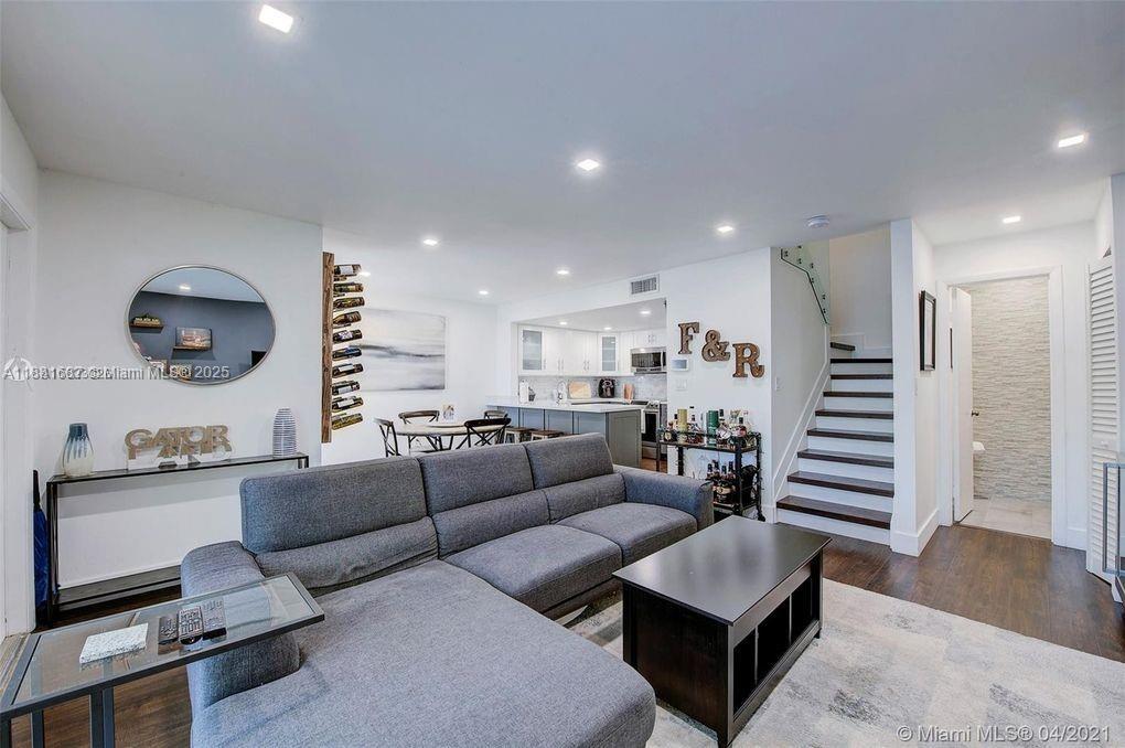 Beautifully Renovated Townhome in Sought-After Gables Point! Step into this rarely available, fully remodeled gem—updated with modern finishes and impact windows and doors for peace of mind. Enjoy your own private entrance with charming synthetic grass, creating a welcoming feel before you step inside. The open-concept layout greets you with seamless flow between the spacious living room, dining area, and stylish kitchen—perfect for entertaining or relaxing at home. A convenient half bath downstairs adds extra functionality for guests. Upstairs, you'll find 2 generously sized bedrooms, each with their own private en-suite bathrooms, offering comfort and privacy. Don't miss out on this move-in ready home in a quiet, well-maintained community close to everything Coral Gables has to offer!