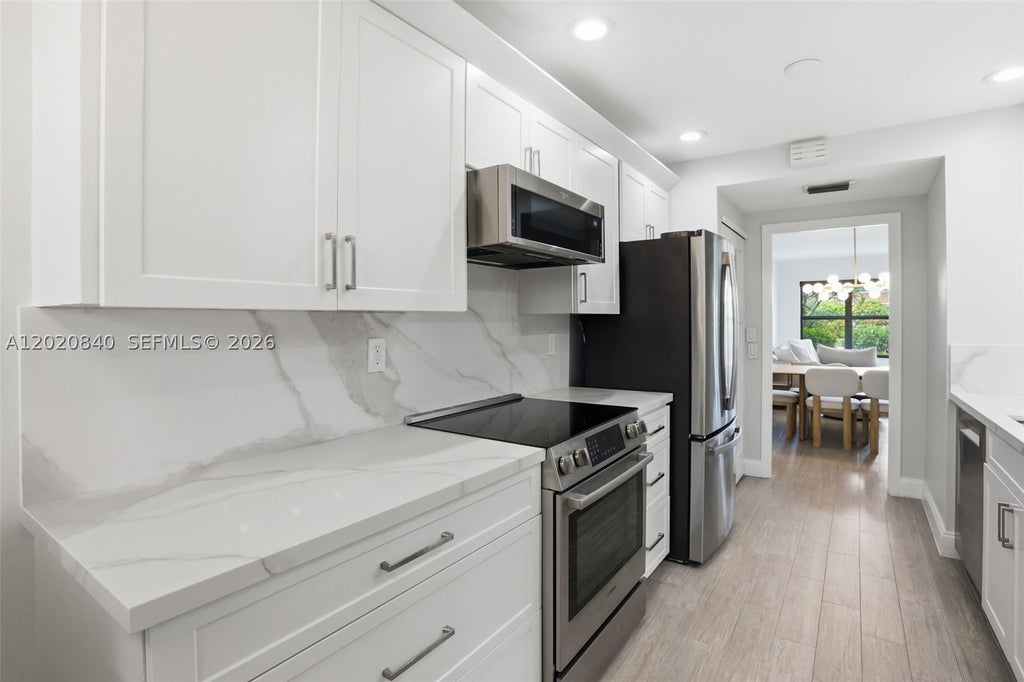 Photo of 830 Greensward Ct #106-H, Delray Beach, FL 33445 (MLS # A12020840)