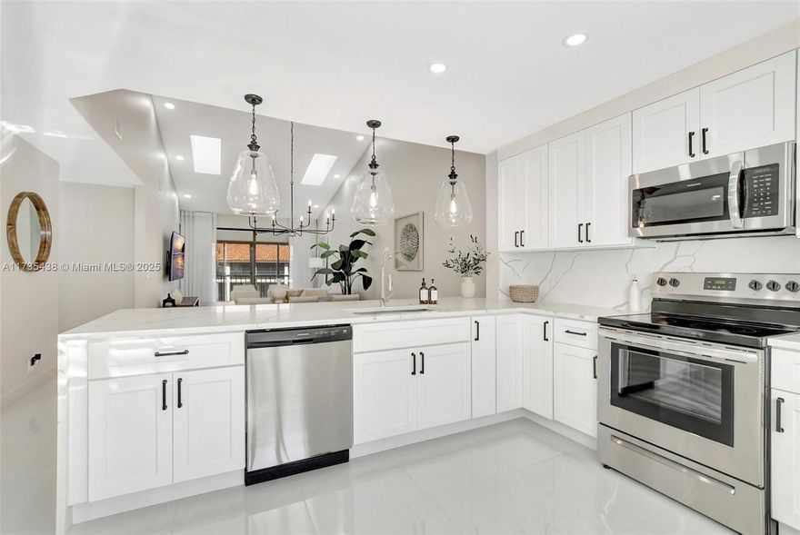 Beautiful completely remodeled Townhouse with 3 bedrooms, 2 bathrooms and 1 car garage in La Mirada, in Boca Pointe. Wow! Walk your way up to admire the combines luxury and comfort with impeccable design. The kitchen features white cabinetry and stunning Calacatta countertops, creating a modern, elegant space. White porcelain tile flooring flows throughout, enhancing the open feel, while high ceilings and a skylight bathe the home in natural light. The spacious principal bedroom offers a walk-in closet, and the screened & glassed patio provides a private retreat with serene water views. With a water filter for pure, clean water, a garage for added convenience, and the option for a Boca Pointe Country Club membership, this townhome is the perfect blend of style and practicality.