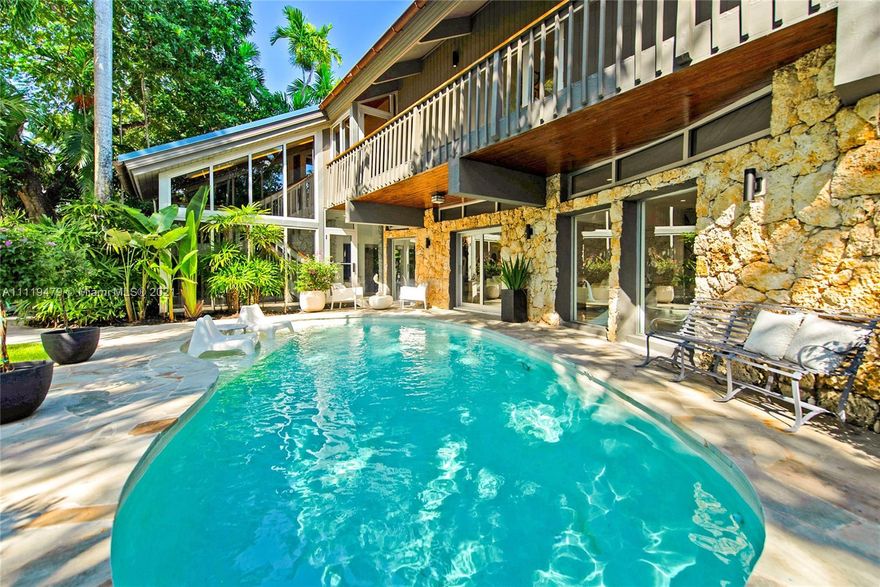 Stunning, totally renovated coastal-contemporary style home in the coveted guard-gated community of Four-Way Lodge Estates. Walk to the Grove village’s cafes, boutiques and bayfront parks & marinas. Set behind a coral rock wall and surrounded by lush tropical landscaping canopied by mature trees. Spectacular, light-filled living spaces with wood-beamed ceilings & walls of glass overlooking the ultra-private pool & garden. European-style kitchen features walk-in pantry, gas range & center island. 4BR’s/4.5BA’s including a ground level guest suite. 2nd level with wrap-around balcony, offers spacious family room, vaulted ceilings & wood flooring. Unique, 3rd level Loft/Den. Sited high on the ridge, this home enjoys 13’ sea-level elevation. Community boat basin with direct ocean access.