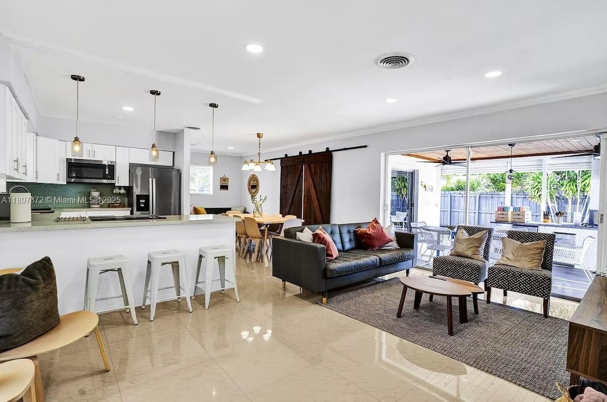 Beautifully renovated 4-bedroom, 3-bath single-family home offered at $699,000. This property features a split floor plan with two master suites, each with a private bath, ideal for multi-generational living or hosting guests.
The interior has been completely updated with modern finishes, new flooring, and high-end fixtures throughout. The open-concept layout seamlessly connects the living, dining, and kitchen areas, creating a bright and inviting atmosphere. Step outside to a private backyard oasis featuring a heated pool, outdoor kitchen, and spacious covered patio, perfect for entertaining. All furniture is included if the buyer wishes. Currently a successful Airbnb & VRBO property! Showings by appointment only.
