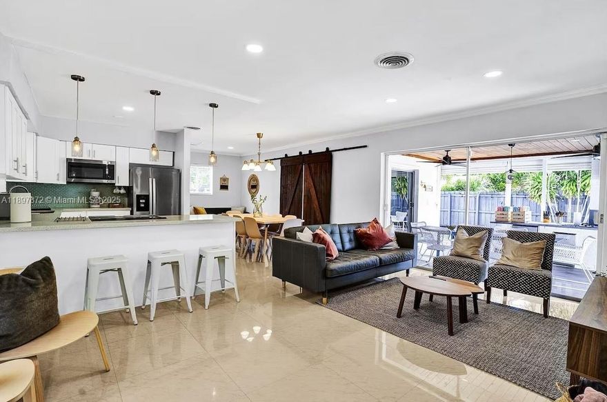 Beautifully renovated 4-bedroom, 3-bath single-family home offered at $699,000. This property features a split floor plan with two master suites, each with a private bath, ideal for multi-generational living or hosting guests.
The interior has been completely updated with modern finishes, new flooring, and high-end fixtures throughout. The open-concept layout seamlessly connects the living, dining, and kitchen areas, creating a bright and inviting atmosphere. Step outside to a private backyard oasis featuring a heated pool, outdoor kitchen, and spacious covered patio, perfect for entertaining. All furniture is included if the buyer wishes. Currently a successful Airbnb & VRBO property! Showings by appointment only.