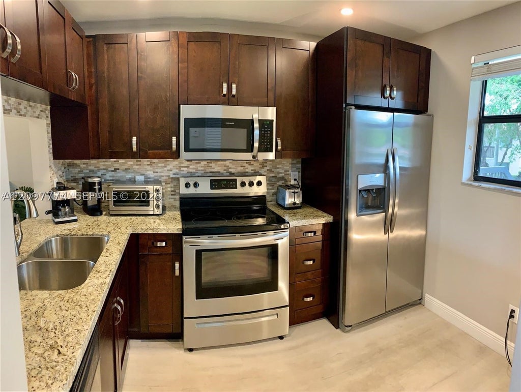 Photo of 15705 W Waterside Cir #203, Sunrise, FL 33326 (MLS # A12097774)