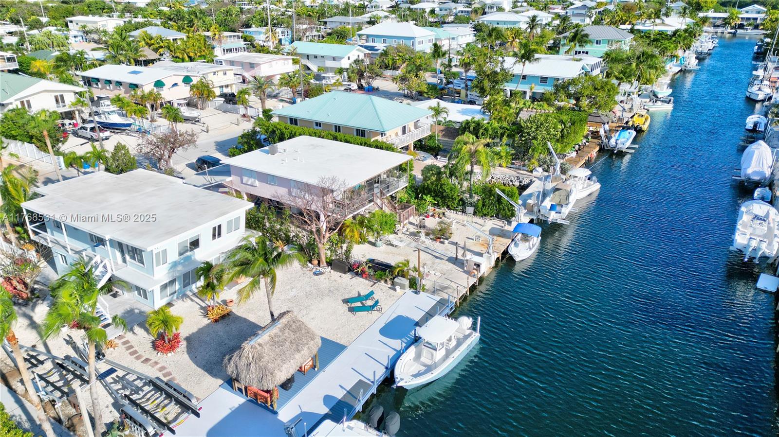 Plantation Key Colony - Completely UPDATED-Like New - 2/1 up and 2/1 down, plus -1- more Extra Room- Great to Live in or Great for Renting out Half and using the other half or making it a Double rental income. Large Concrete Dock 75 Ft. w/ 20,000lb Boat Lift. This Big Lot is 125x75 with a Tiki Hut & Hot Tub. Quick Direct access to Bay & Ocean. Beautiful Homeowners Park on the Bay with a Beach & Boat Ramp. Plenty of room for a new pool. Centrally located near Shopping, Schools, Restaurants and more.